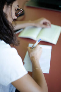 Psychology student taking notes from a textbook