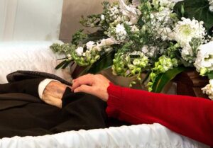 funeral scene wife touching husband for last time